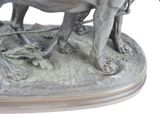 a statue of a man on a horse that is pulling a cart