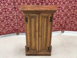 a small wooden cabinet with two doors on it