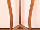 a small wooden table with a glass top on a hard wood floor