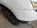 a close up of the front bumper of a white car