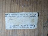 a label on a piece of wood that is on a table