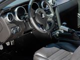 the interior of a white car with black leather seats and a steering wheel