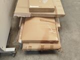 a pile of boxes sitting on the floor next to a wall