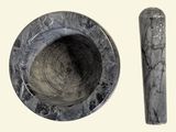 a marble mortar and a wooden spoon on a table