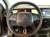 the interior of a car with a steering wheel and dashboard controls