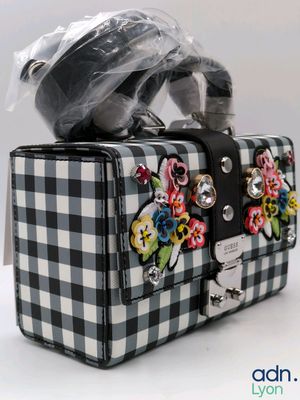 a black and white checkered purse with flowers on it
