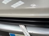 a sticker on the front of a silver car