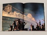 an open book with a picture of a cruise ship in the background