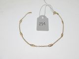 a close up of a gold bracelet with a price tag on it