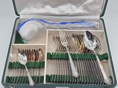 a green case with silverware in it on a table