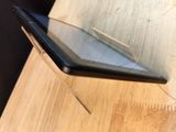 a cell phone sitting on top of a wooden table