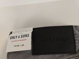 grey jeans with a black label on the back of it