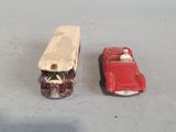 two toy cars sitting next to each other on a table