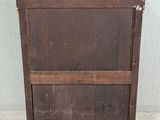 an old wooden cabinet sitting on top of a tiled floor