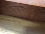 a close up view of a wooden shelf with a drawer underneath it
