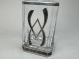 a glass container with a design on it on a table