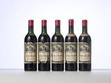 four bottles of wine are lined up on a table