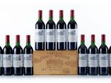 six bottles of red wine in a wooden crate on a white background