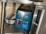 a small oven that is sitting in the corner of a kitchen