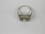 a close up of a diamond ring on a white surface
