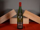 a bottle of wine sitting on a table next to a wooden box