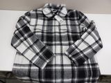 a picture of a black and white plaid shirt sitting on a table