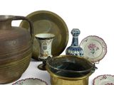 many different types of vases and plates on the table