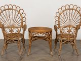 two wicker chairs and a small table on a tiled floor