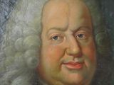 portrait of a man with white hair wearing a blue coat