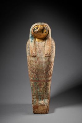 an egyptian painted wooden statue of a woman
