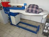 a bed with a blanket on top of it in a room