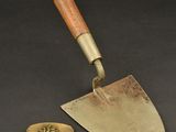 an old metal and wood handled trowet with a wooden handle
