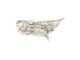 a close up of a bird brooch with diamonds on it ' s wings