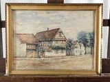 tableau représentant une maison posée sur un chevalet en bois, avec un rideau blanc en arrière-plan