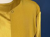 a close up of a mannequin mannequin wearing a gold dress