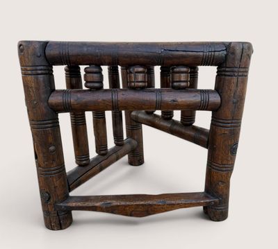 a wooden chair that has a wooden seat on it