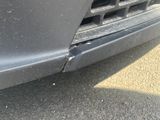 a close up of a car ' s front bumper with a hole in it