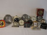 many different types of clocks displayed on a table