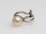 an image of a pearl and silver ring on a white surface