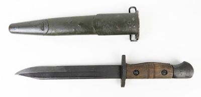 an old knife with a wooden handle sitting next to a smaller knife