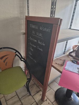 a chalk board on the table next to a chair