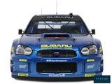 a subaru rally car that is parked on the side of the road