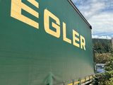 a green and yellow truck that is parked on the side of the road