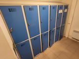 several blue lockers are lined up in a room with tile flooring