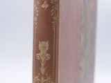 an old book sitting on top of a wooden table