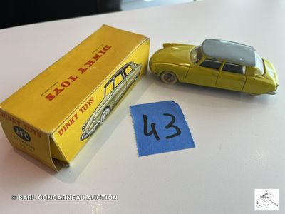 une petite voiture jaune à côté d'une boîte jaune sur laquelle figure un numéro