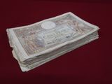 a stack of money sitting on top of a red table