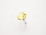 a yellow diamond ring on a white background