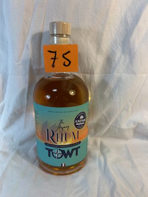a bottle of rum that is sitting on a white sheet