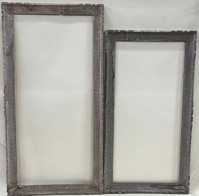 Deux cadres en bois sculpté et cérusé.